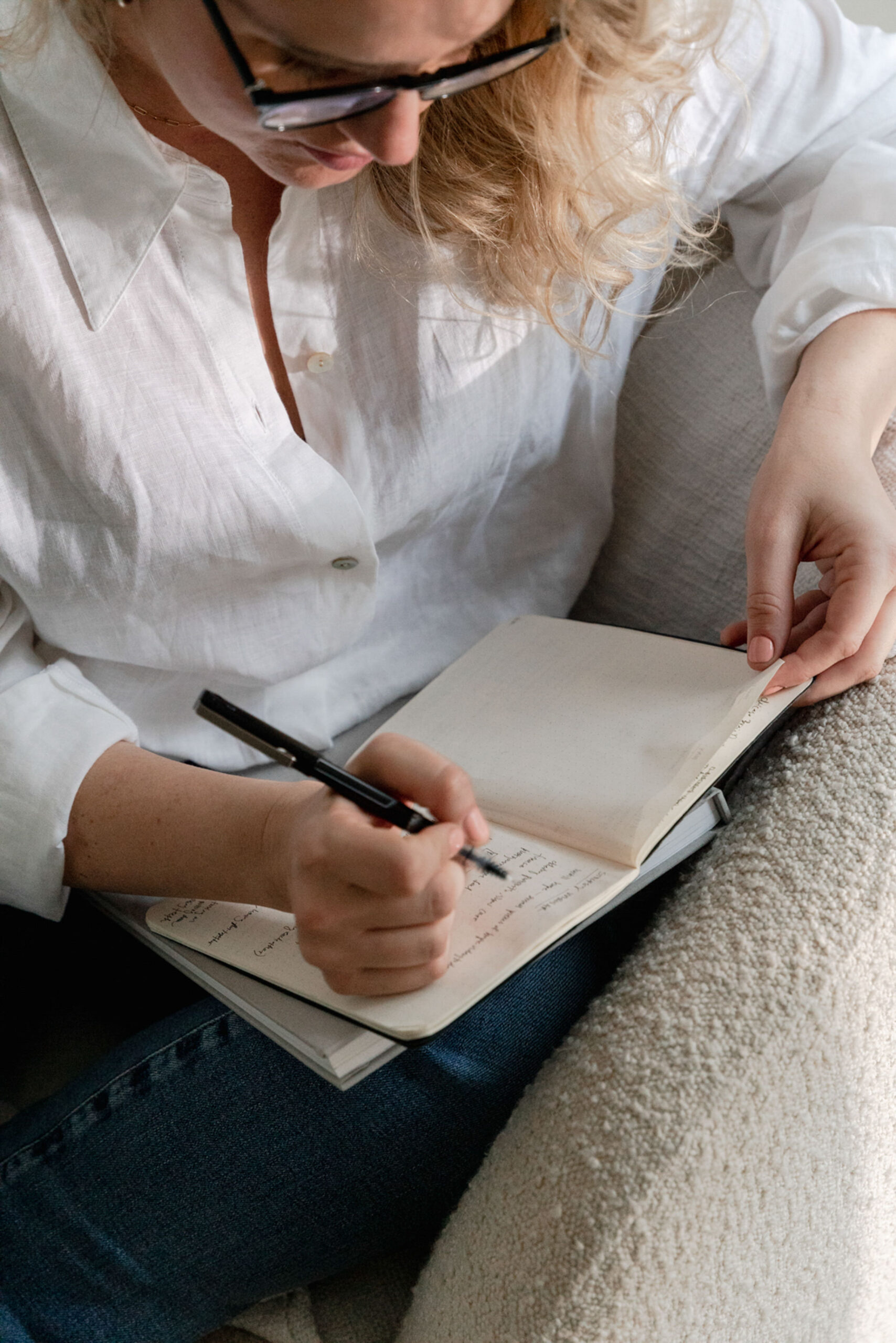 woman writing and taking action on her goals